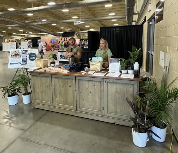 Man and women at Build & Remodel event desk.