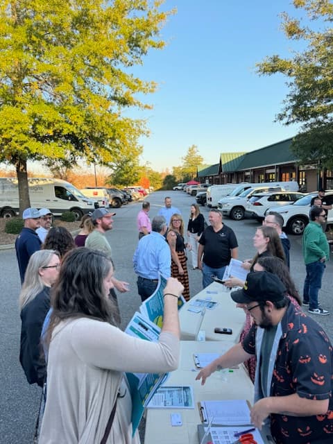 People distributed handouts to others and mingling.