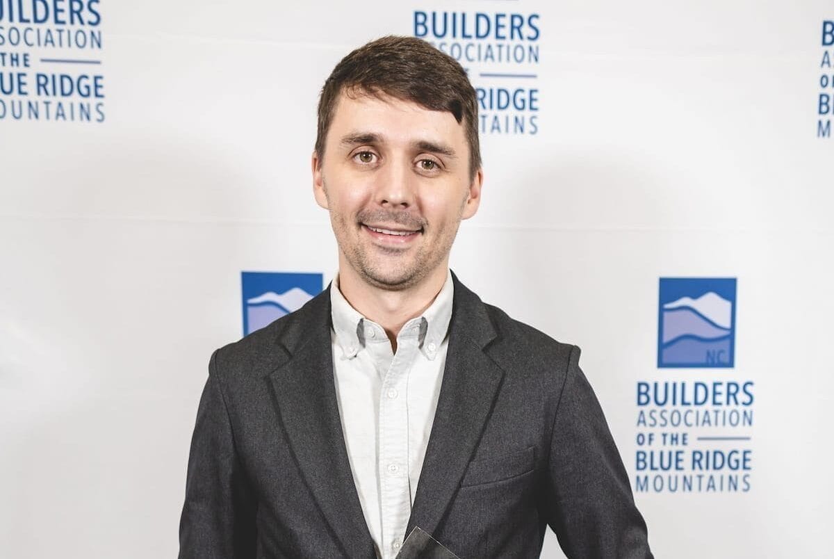 Mitchell Metz holding his 2025 Associate of the Year award