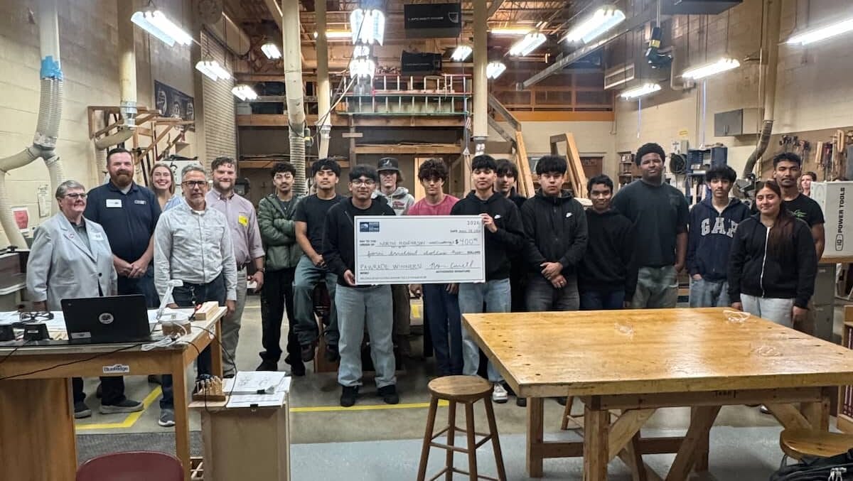 North Henderson High School students holding check for winning the Pawrade of Homes